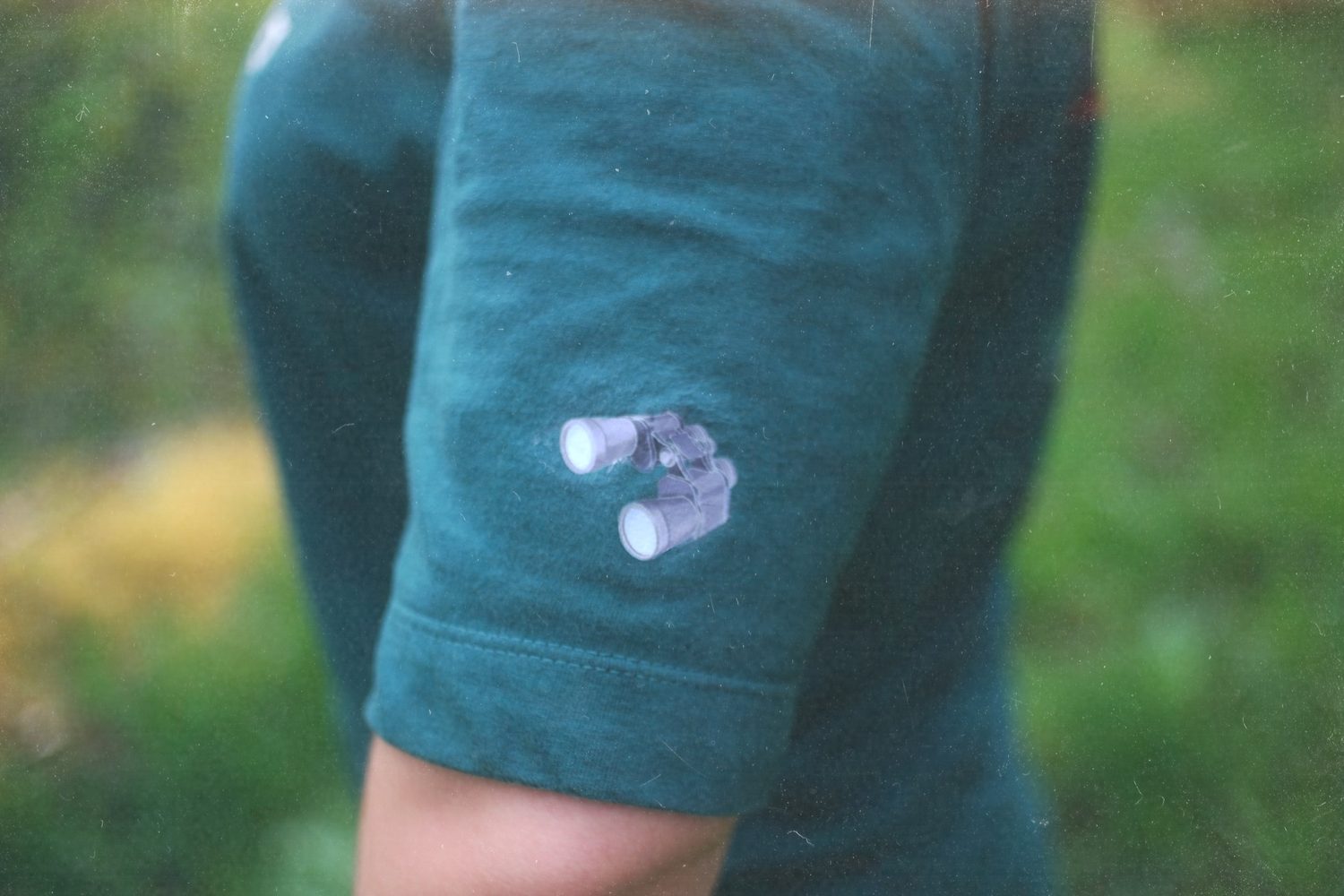 Close-up of the binoculars print on the sleeve.
